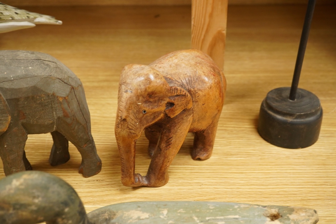 A carved and painted decoy duck, two carved elephants and two other painted birds, tallest 41cm